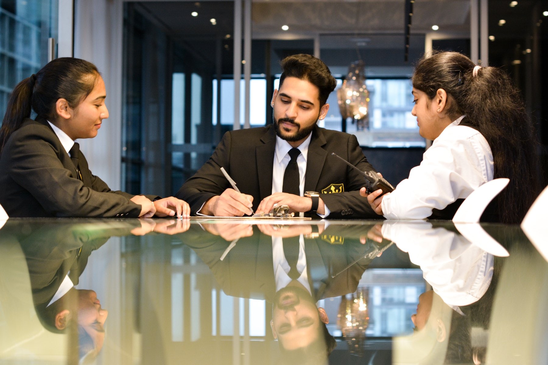 Royal officers in a briefing at a condominium front desk